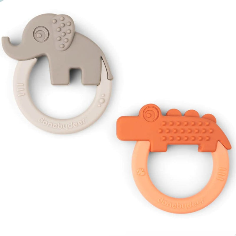 Anneaux de dentition gris et orange devant un fond blanc 